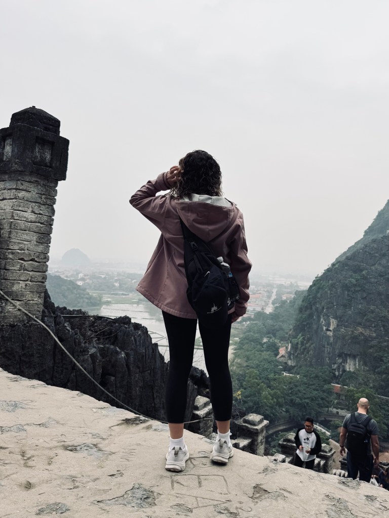 Girl looking out at views on the Mua Cave hike in Ninh Binh, Vietnam