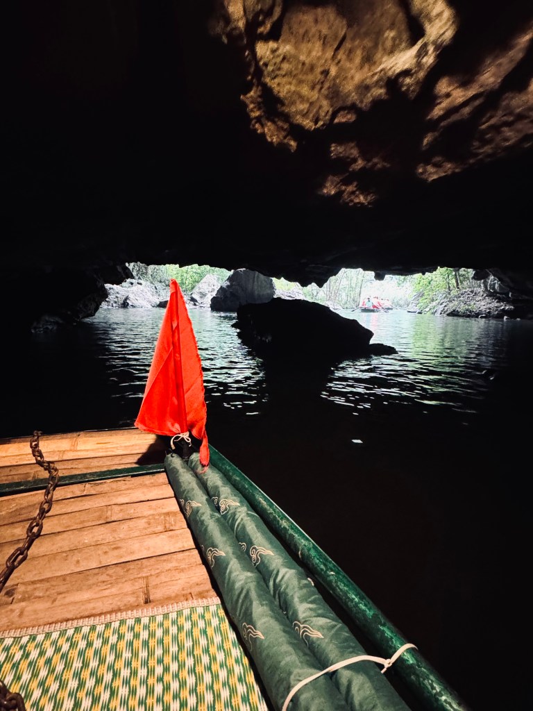 Boat going through cave on Trang An boat ride in Ninh Binh, Vietnam
