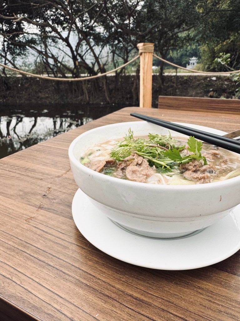 Table with bowl of Vietnamese pho.