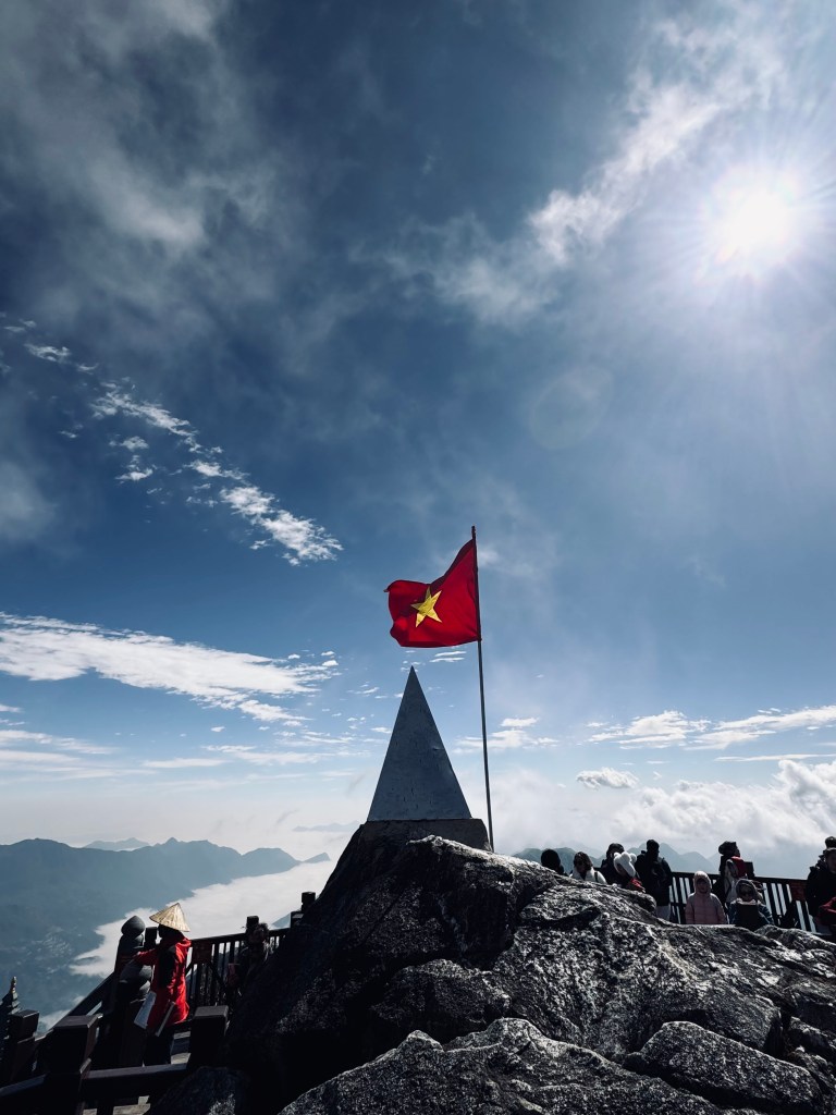 Peak of Fansipan Mountain with Vietnamese flag in Sapa, Vietnam