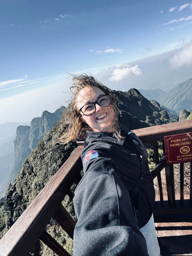 Girl taking selfie at the top of Fansipan Mountain in Sapa, Vietnam