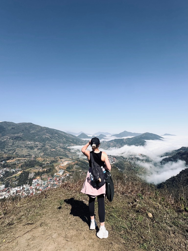 Girl looking out at mountain views on Sapa town on a trekking tour in Sapa, Vietnam