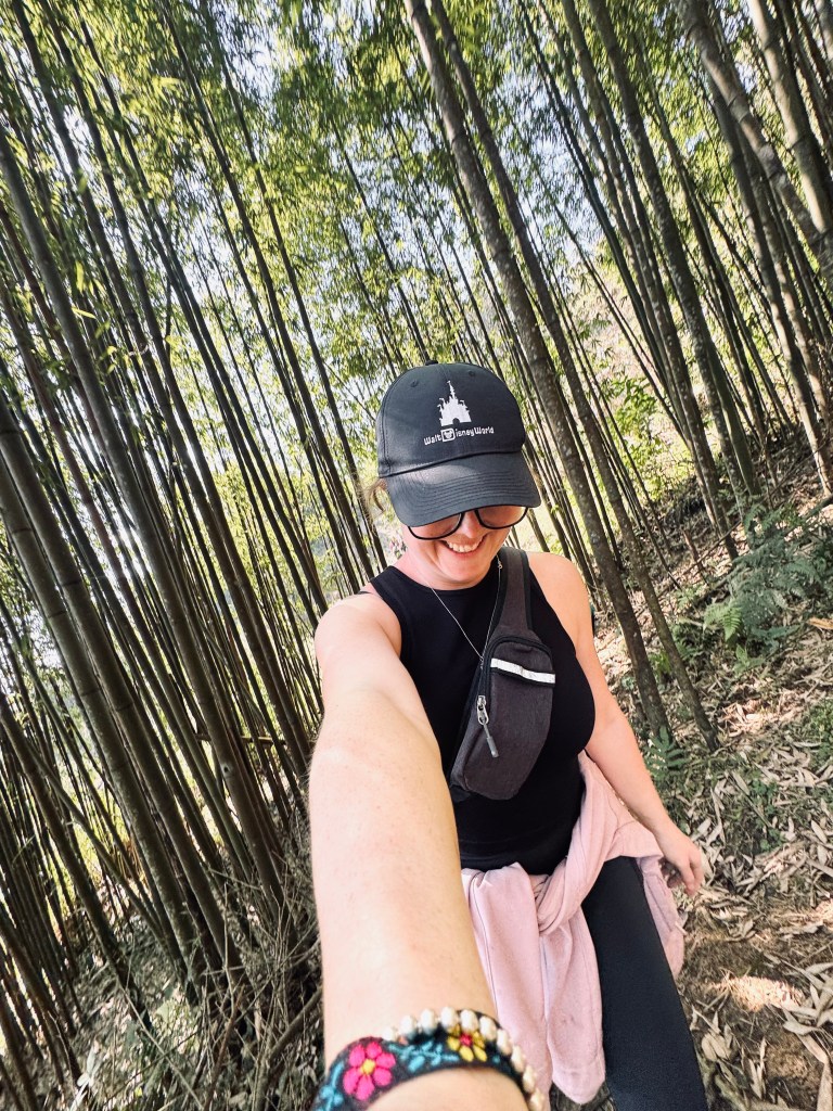 Girl walking through a bamboo forest on a trekking tour in Sapa, Vietnam