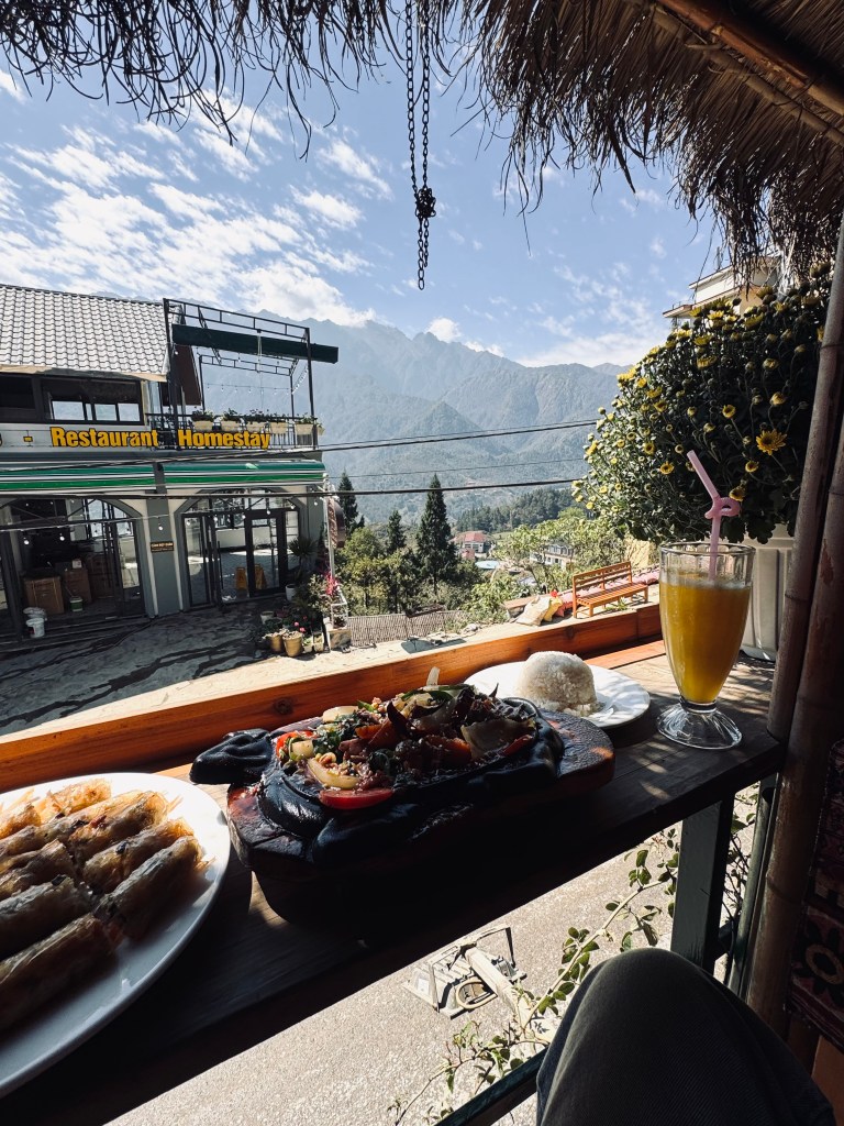 Lunch of spring rolls and hot plate with mountain views in Sapa, Vietnam