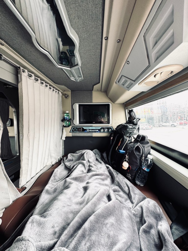 VIP Sleeper bus bunk bed with blanket and TV and privacy curtain in Vietnam