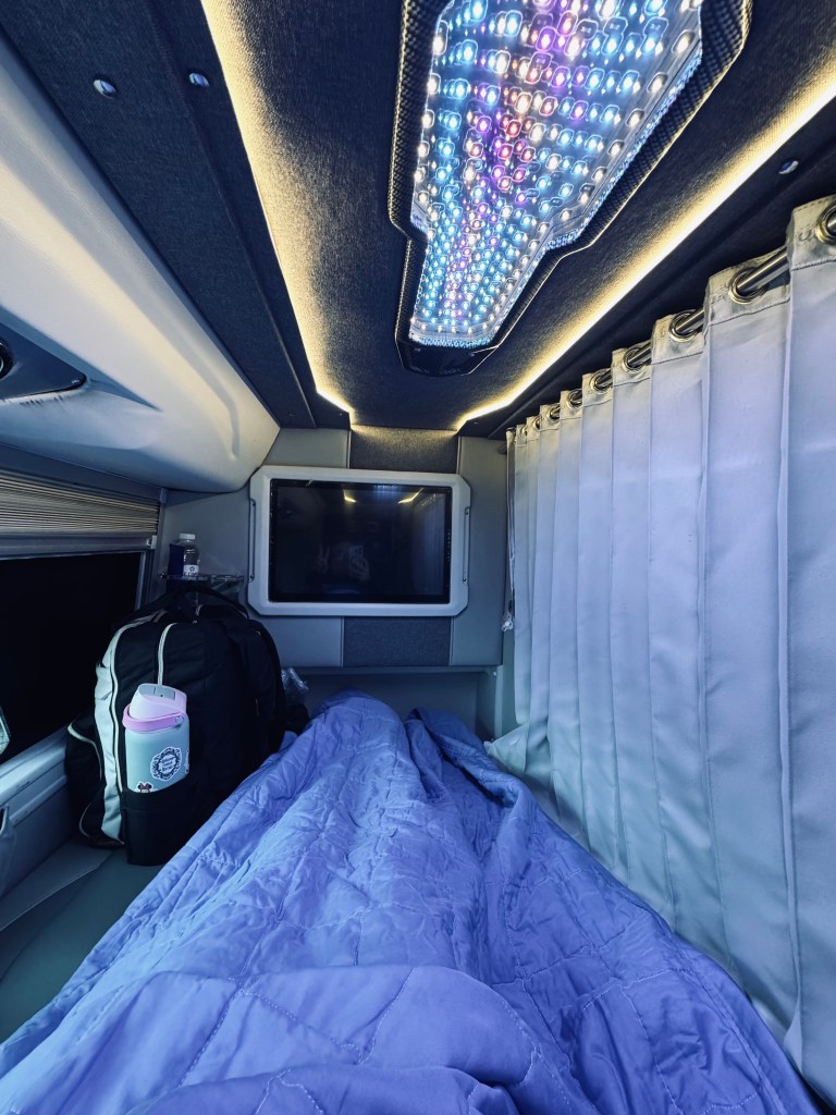 VIP Sleeper bus bunk bed with blanket and TV and privacy curtain in Vietnam